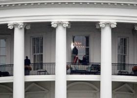 Law enforcement officers photograph a window  at the White .