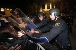 Police officers with the Berkeley Police Department clash with protesters during a march against the New York City grand jury decision to not indict in the death of Eric Garner in Berkeley, California December 8, 2014. REUTERS/Stephen Lam