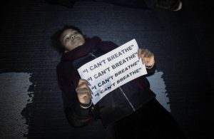 A woman lies down in the street as she takes part of a protest on 6th Avenue in Manhattan after a grand jury decided not to indict New York Police Officer Daniel Pantaleo in Eric Garner's death on December 3, 2014 in New York City. (Kena Betancur/Getty Images)