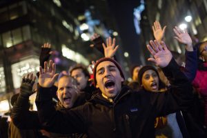 People take part in a protest against the grand jury decision on the death of Eric Garner in midtown Manhattan in New York December 3, 2014. (REUTERS/Eric Thayer)