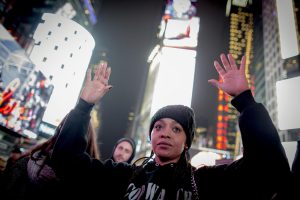 A demonstrator holds her hands up during a protest against the grand jury decision in the Eric Garner case, in Times Square in New York December 3, 2014. (REUTERS/Brendan McDermid)