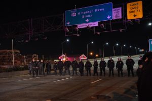 NYPD officers stand on West Side Highway during a protest to a non indictment against a police officer in the death of Eric Garner, Wednesday Dec. 3, 2014, in New York. (David Handschuh/Yahoo News)