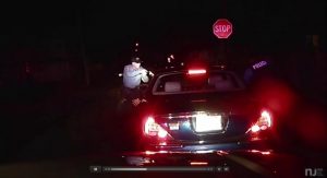 Two Bridgeton, N.J., police officers are seen with guns drawn after a Dec. 30 traffic stop led to the alleged discovery of a handgun in a car carrying a convicted police shooter, who was recognized by an officer.