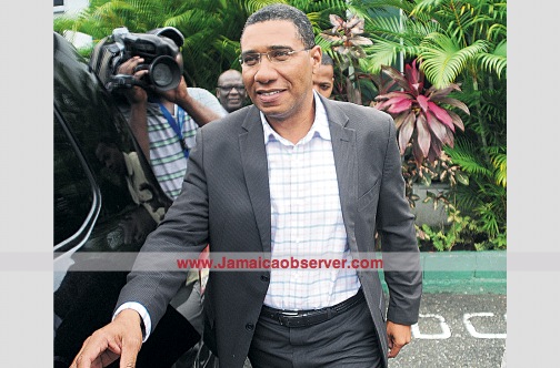 Opposition Leader Andrew Holness wears a broad smile as he walks to his motor vehicle to leave the Jamaica Labour Party headquarters yesterday afternoon after Opposition MPs voted to have him remain as leader of the party. (PHOTO: GARFIELD ROBINSON)