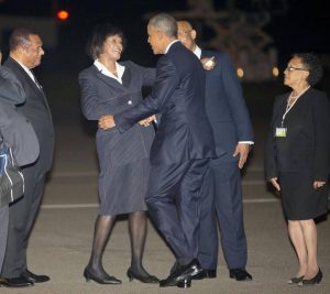 U.S. President Barack Obama, center, is greeted by with Prime Minister Portia Simpson-