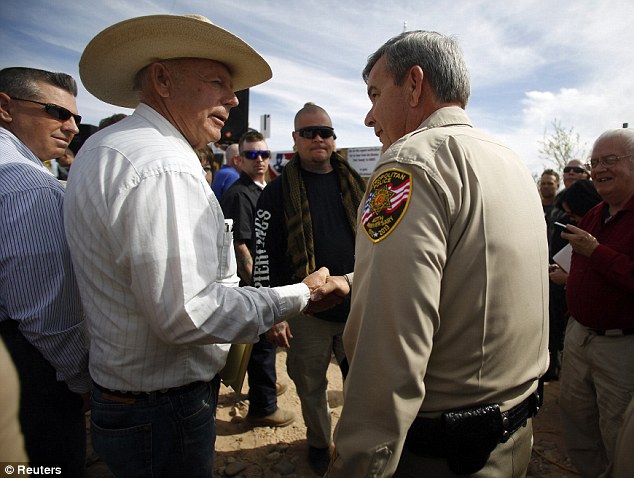 Deal: Cliven Bundy shakes hands with Sheiff Doug Gillespie on Saturday morning as the rancher comes to a deal to stop federal agents rounding up his cattle Read more: http://www.dailymail.co.uk/news/article-2603026/Senator-speaks-favor-Nevada-rancher-militias-join-battle-federal-agents-accused-acting-like-theyre-Tienanmen-Square-fight-disputed-ranch-land.html#ixzz3YiB6S8iW  Follow us: @MailOnline on Twitter | DailyMail on Facebook
