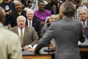 North Charleston, S.C., Mayor Keith Summey (l.) watches as Rev. Al Sharpton (foreground) speaks at Charity Missionary Baptist Church on Sunday in the wake of the killing of Walter Scot