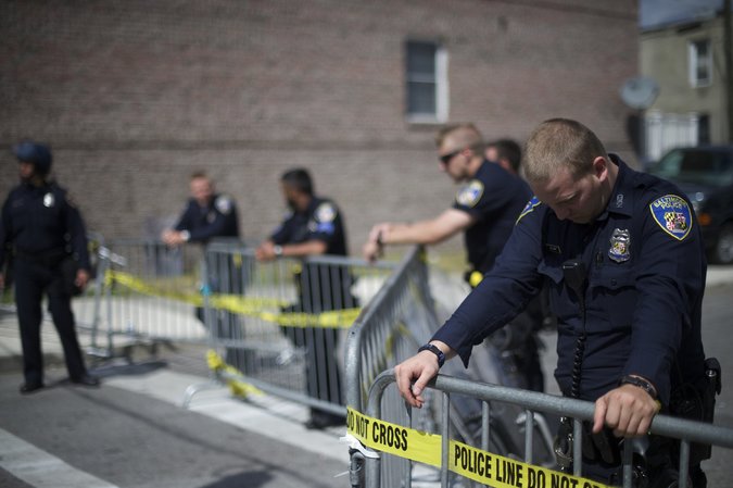 Police officers erecting a barricade in Baltimore on Tuesday. Even before protests about the death of Freddie Gray, complaints were made about a state law that gives special legal protections to officers suspected of abusing their power. Credit Mark Makela/Getty Images