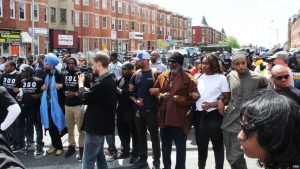 People in Baltimore stand against police violence.