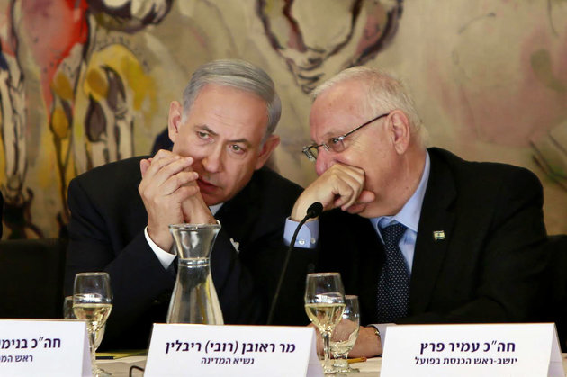 Israel's Prime Minister Benjamin Netanyahu, left, and Israeli President Reuven Rivlin, right, speak during an event following the first session of the newly-elected Knesset in Jerusalem, Tuesday, March 31, 2015. (AP Photo/Gali Tibbon, Pool)