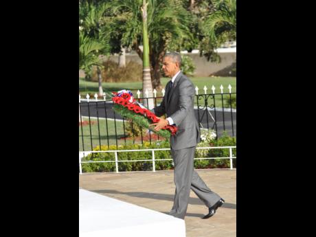 US President Barack Obama lays a wreath in honour of war dead at National Heroes Park in April. A correspondent has recommended that a monument to honour slain police be established at the park.