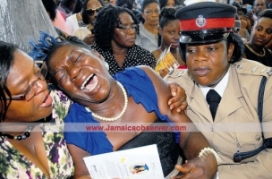 The mother of police constable Crystal Thomas cries uncontrollably.