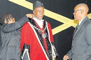 Glendon Harris being sworn in as Mayor of Montego Bay. Notice that the Jamaican flag which is being depicted behind the City's new chief Executive has no green in in it....