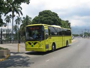 A publicly owned bus , part of the transportation system in Jamaica