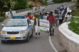 Young people of Steer Town in St. Ann receive support from the police as they march against drug abuse, gang violence and other social ills last Saturday ...