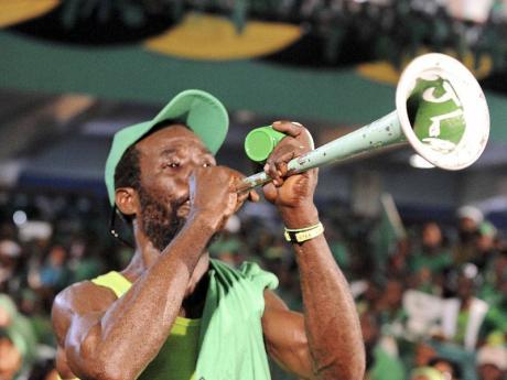 A JLP supporter blows a vuvuzela. - photos by Ian Allen/Photographer