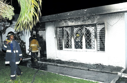 Firefighters work at putting out a blaze that gutted this fourbedroom house at 3 Benson Terrace in Norbrook, St Andrew.