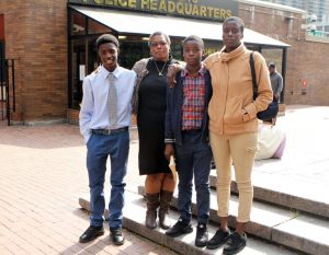 From left to right: Kesean Smalls, 15; his grandmother, Yvonne Smalls, 50; Jahniel Hinds, 14; his mom, Corinia Sivers, 39, stand outside police headquarters on Thursday.