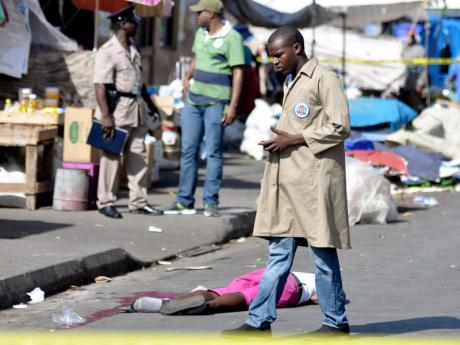 Police on the scene where 48-year-old Stenneth Smith was killed in downtown Kingston 