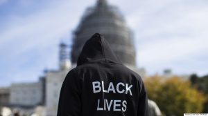Neal Blair, of Augusta, Ga., stands on the lawn of the Capitol building during a rally to mark the 20th anniversary of the Million Man March, on Capitol Hill, on Saturday, Oct. 10, 2015, in Washington. Thousands of African-Americans crowded on the National Mall Saturday for the 20th anniversary of the Million Man March. (AP Photo/Evan Vucci)