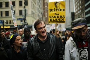 Quentin Tarantino (c.) takes part in a march against police brutality called "Rise up October" on Oct. 24 in New York