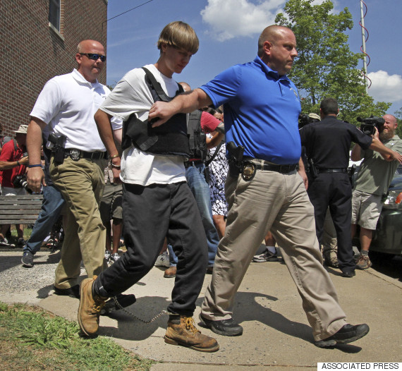 Charleston, S.C., shooting suspect Dylann Storm Roof, second from left, is escorted from the Shelby Police Department in Shelby, N.C., Thursday, June 18, 2015. Roof is a suspect in the shooting of several people Wednesday night at the historic The Emanuel African Methodist Episcopal Church in Charleston, S.C. (AP Photo/Chuck Burton)
