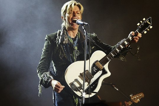 NEWPORT, ENGLAND - JUNE 13: David Bowie performs on stage on the third and final day of "The Nokia Isle of Wight Festival 2004" at Seaclose Park, on June 13, 2004 in Newport, UK. The third annual rock festival takes place during the Isle of Wight Festival which runs from June 4-19. (Photo by Jo Hale/Getty Images) *** Local Caption *** David Bowie Image by Getty Images