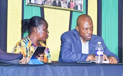 A female vendor makes a complaint to Commissioner of Police Dr Carl Williams during the town hall meeting