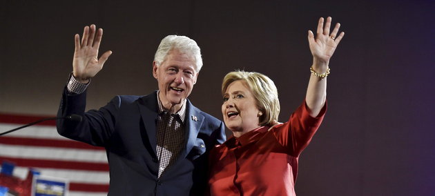 Democratic U.S. presidential candidate Hillary Clinton and her husband former President Bill Clinton wave to supporters after she was projected to be the winner in the Democratic caucuses  in Las Vegas, Nevada February 20, 2016. REUTERS/David Becker      TPX IMAGES OF THE DAY