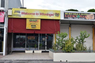 The business operated by Andrew Davis and Helen McGoo at Southdale Plaza remained closed yesterday, following their murder on Monday night. Observer photo